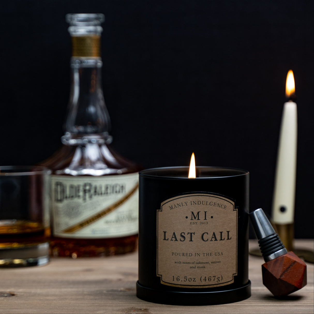 image of the product classic last call placed on its lid with a lit taper candle and bourbon placed in the background