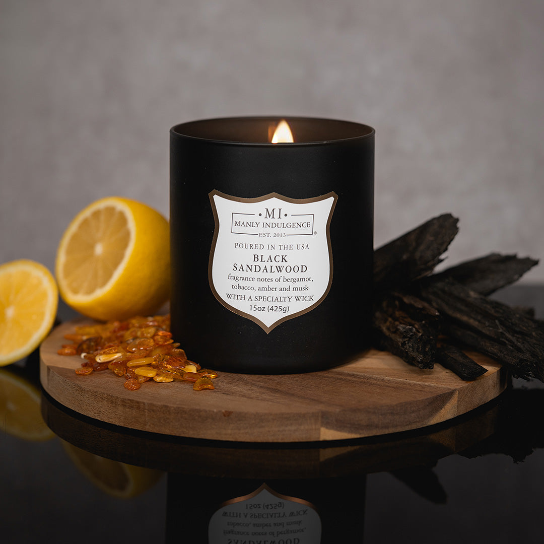 An image of the Signature Woodland Escape candle with its fragrance ingredients in the background.