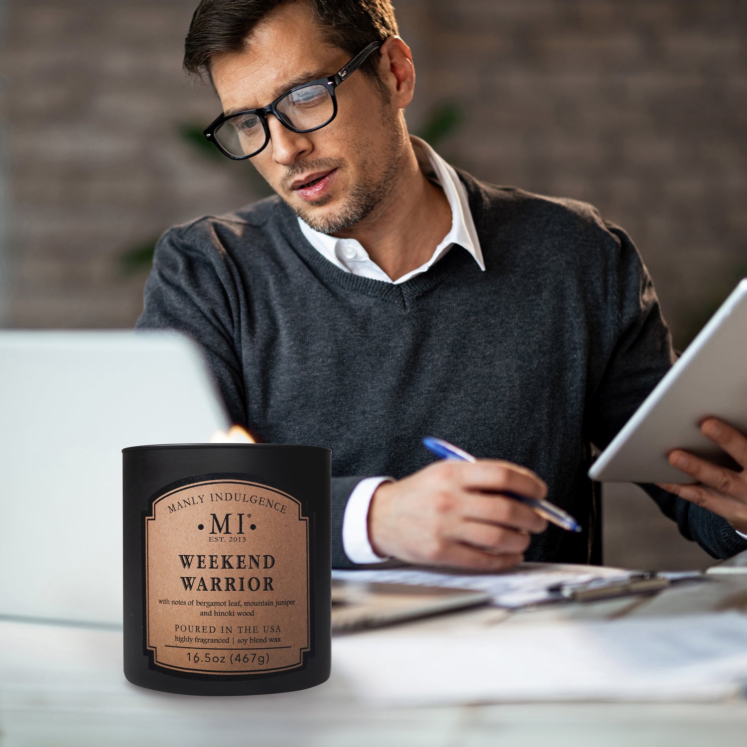 an image of the candle classic plus weekend warrior placed on table with a man working on his computer