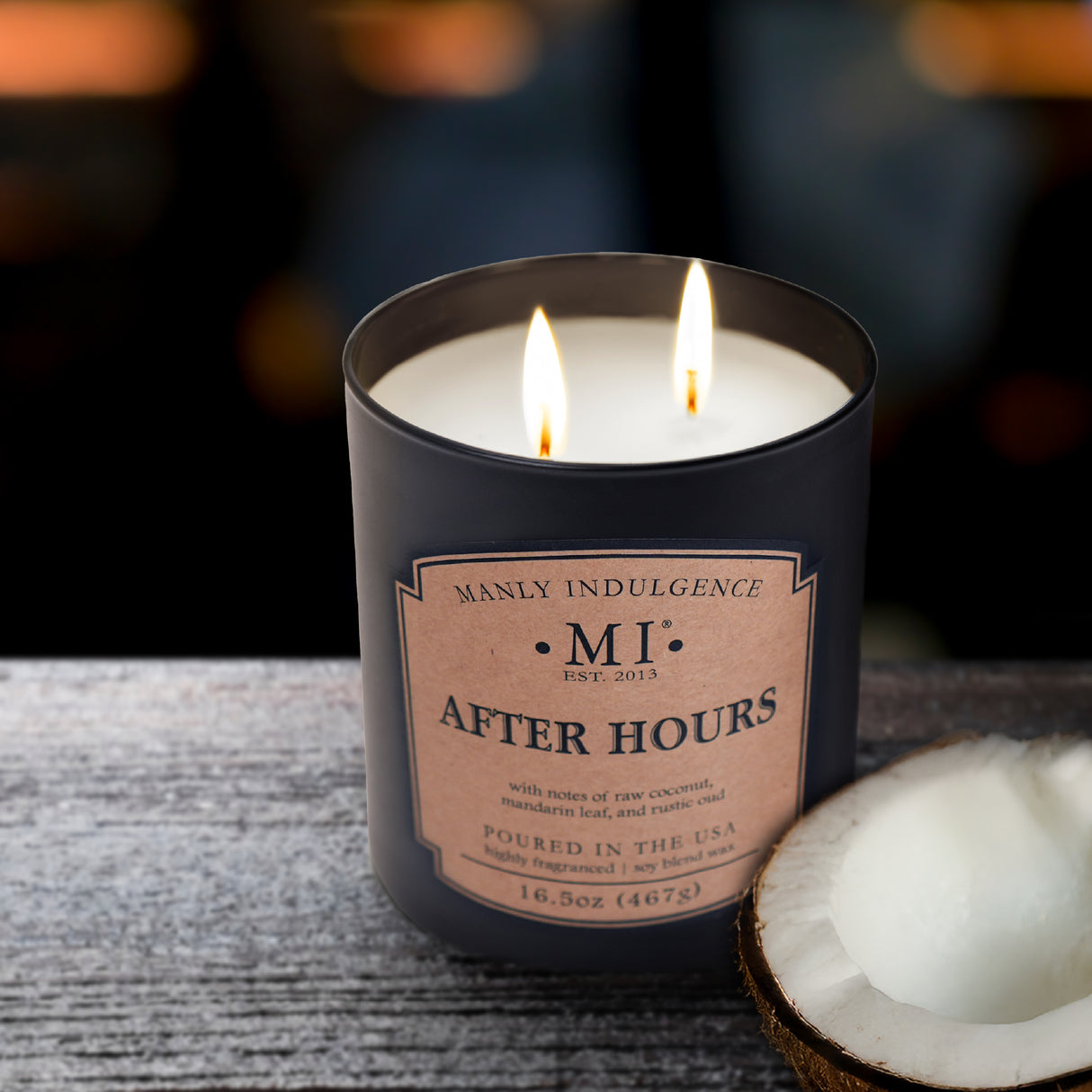 Candle labeled 'Manly Indulgence After Hours' with a coconut on a textured surface.