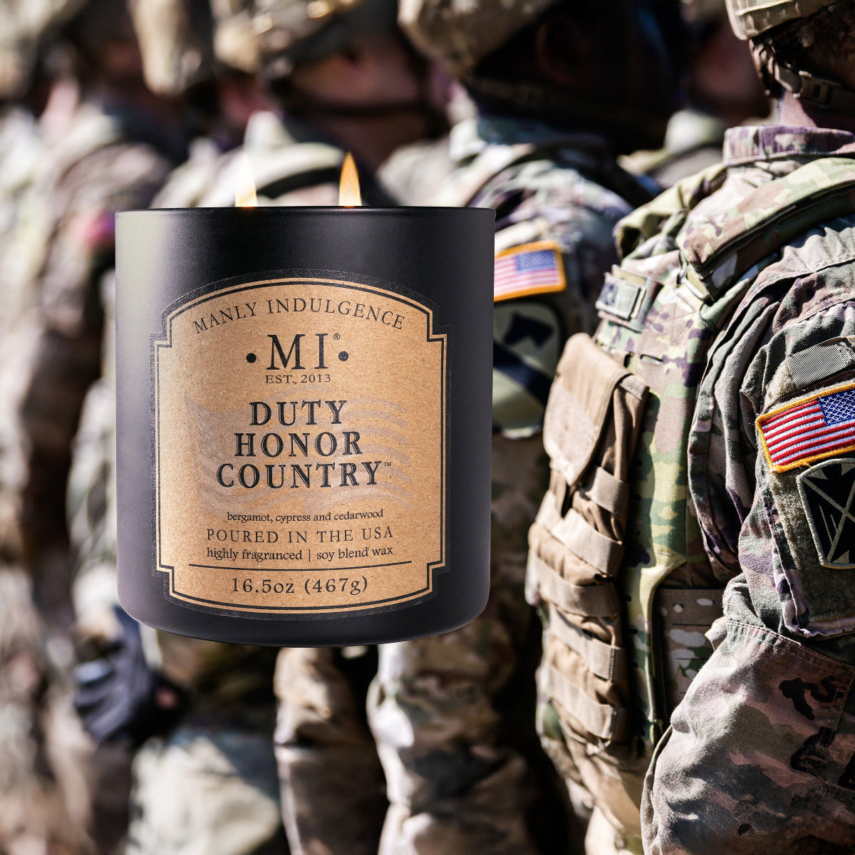 An image of the candle Classic Plus Duty Honor Country against a background of army personnel in training