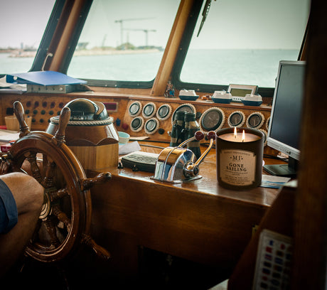 a picture of a candle placed on the inner deck of  boat at sea