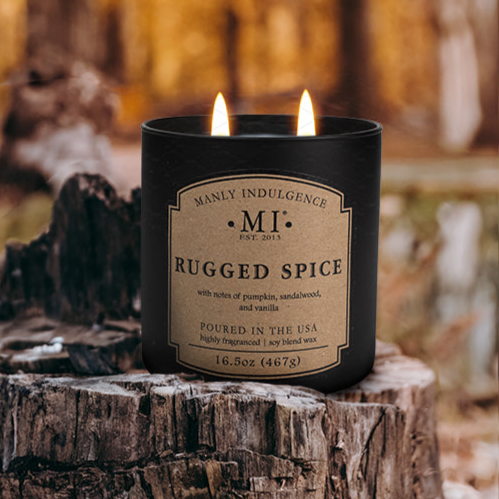an image of the candle classic plus Rugged Spice placed on a wooden stump with a forest in the background